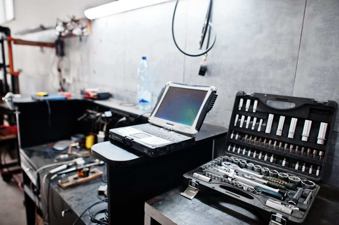 laptop-and-tools-in-maintenance-at-garage-service-station-.jpg